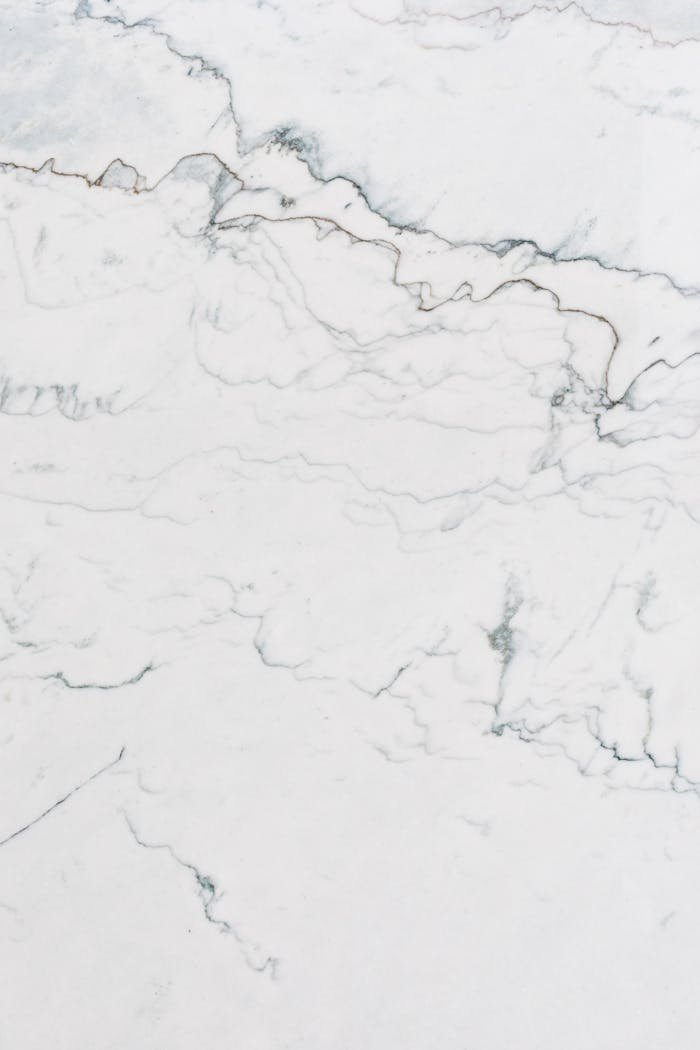 High-resolution white marble texture with natural veining patterns, perfect for backgrounds.